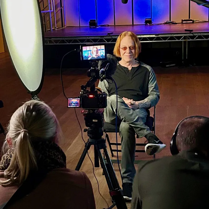 Camera and lighting setup for an interview on a stage