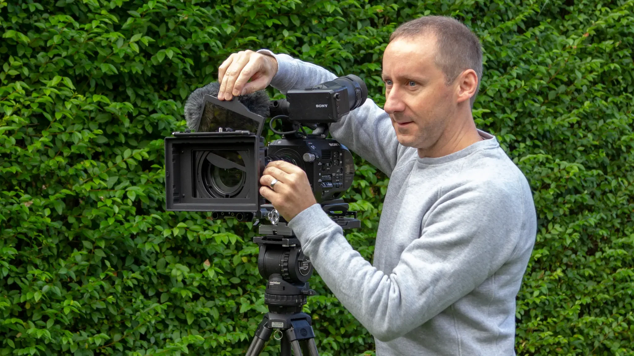 Elliot Hornell adjusting his camera on location