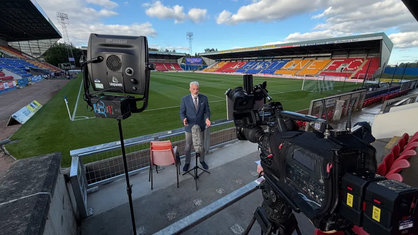 Broadcast camera setup for a presenter interview at a football stadium